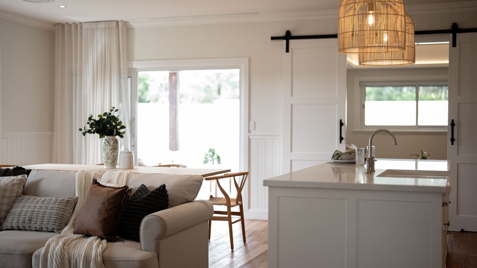 Styled open-plan living and kitchen in a Mittagong home, with natural light and neutral furnishings